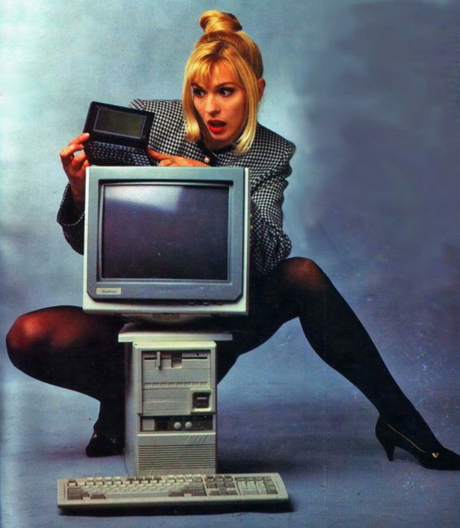 Nineties promo photo, a person crouched behind a beige PC and CRT monitor