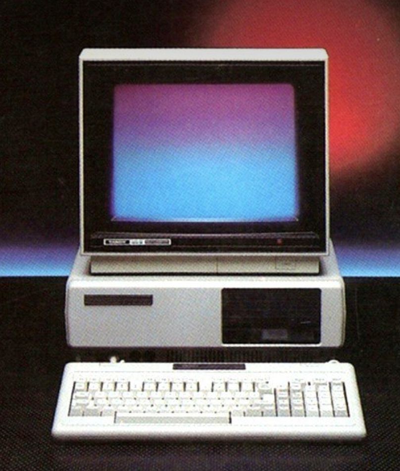 Beige desktop computer with a glowing CRT, studio lit
